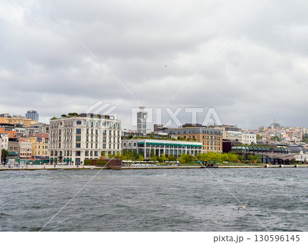 City waterfront view with historic hotel and modern buildings. Tourism, urban lifestyle, and architectural diversity in Istanbul. 130596145