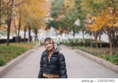 woman traveler visiting in Shanghai, China. Happy Female Tourist sightseeing Shanghai view in The Bund of Shanghai in Autumn season. landmark and popular for tourism attractions. Travel and Vacation 130597465