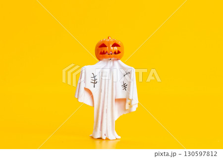 Halloween Ghost with Jack O Lantern Head Isolated on Yellow Halloween Ghost with Jack O Lantern Head Isolated on Yellow 130597812