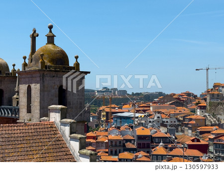 Church in Porto with dome and bell tower, historical Catholic landmark above tiled rooftops, 130597933