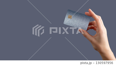 Currency control concept. Bankcard grip, secure fund, finance, profit, credit, cashback, closeup Currency control concept. Bankcard grip, secure fund, finance, profit, credit, cashback, closeup 130597956
