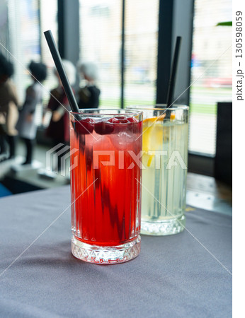 Cold lingonberry drink on restaurant table. Iced cowberry tea, refreshing cranberry cocktail Cold lingonberry drink on restaurant table. Iced cowberry tea, refreshing cranberry cocktail 130598059
