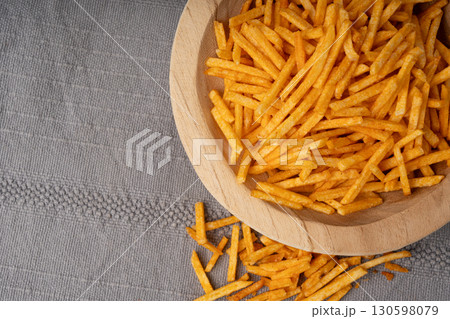 Fried chips sticks, finger potato chips, golden shoestring fries pile, French fries 130598079