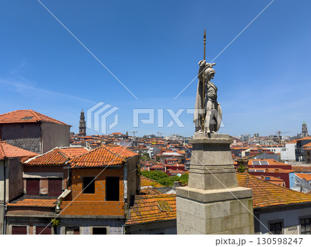 Statue in Porto, Portugal, medieval warrior with spear overlooking cityscape, red tiled rooftops, 130598247