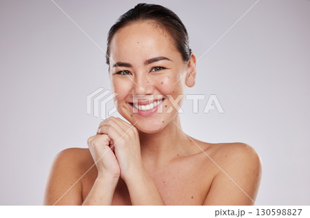 Face portrait, skincare and smile of woman in studio isolated on a gray background. Makeup, beauty cosmetics and happy female model with glowing, healthy or flawless skin after spa facial treatment. Face portrait, skincare and smile of woman in studio isolated on a gray background. Makeup, beauty cosmetics and happy female model with glowing, healthy or flawless skin after spa facial treatment. 130598827