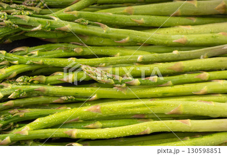 Bunch of Raw Garden Asparagus Textured Background. Fresh Green Spring Vegetables Bunch of Raw Garden Asparagus Textured Background. Fresh Green Spring Vegetables 130598851