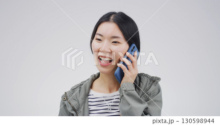 Happy, asian woman and studio with phone call for communication or chat on a white background. Female person, listening or laughing with mobile smartphone for friendly discussion on mockup space Happy, asian woman and studio with phone call for communication or chat on a white background. Female person, listening or laughing with mobile smartphone for friendly discussion on mockup space 130598944