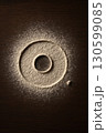 Negative donut imprint in flour on dark wooden surface 130599085