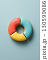 Donut pie chart with colorful icing segments on pastel background 130599086