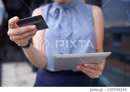 Businesswoman, hands and tablet with credit card for ecommerce, online shopping or banking outdoors. Hand of female holding touchscreen with 5G connection for internet purchase or app transaction 130599244