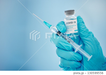 Doctor, hands and covid vaccine for cure, healthcare or medical syringe medication to combat the virus. Hand of nurse holding corona virus sample with needle for vaccination from illness or disease Doctor, hands and covid vaccine for cure, healthcare or medical syringe medication to combat the virus. Hand of nurse holding corona virus sample with needle for vaccination from illness or disease 130599556