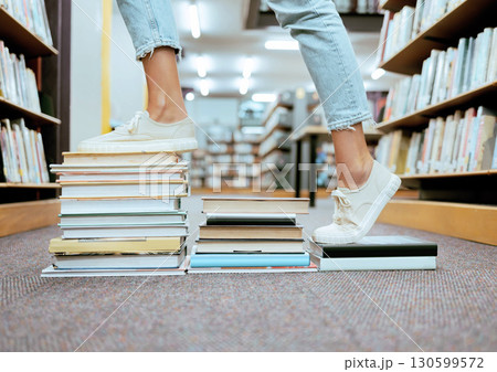 Woman feet, book steps and library for symbol of progress in learning, education and development for study goals, University student, cropped and shoes with paper stairs on floor to success vision Woman feet, book steps and library for symbol of progress in learning, education and development for study goals, University student, cropped and shoes with paper stairs on floor to success vision 130599572