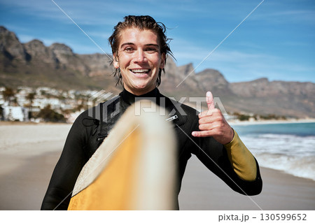 Shaka hand sign, beach and surfer with surfboard for fitness, fun and adventure on vacation. Sports, travel and portrait of man with chill gesture for surfing by the ocean on holiday in South Africa. 130599652
