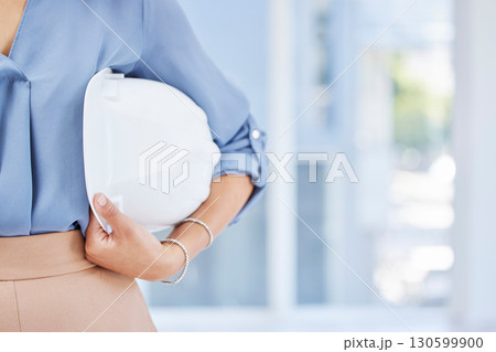 Woman, hands and helmet for construction safety, building or contractor ready for a job on site at office. Hand of female employee engineer or builder holding white hard hat for safe work security 130599900