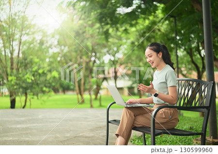 Young woman working remotely on her laptop outdoors, embracing the digital nomad lifestyle Young woman working remotely on her laptop outdoors, embracing the digital nomad lifestyle 130599960