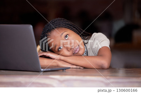 Bored black woman, laptop and thinking in remote work resting head on table in thought for business plan. Tired African female freelancer wondering, dreaming or relaxed by computer contemplating idea 130600166