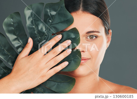 Palm leaf, face and woman in portrait with hand for beauty, manicure and natural cosmetics isolated on studio background. Eco friendly cosmetic care, facial and skincare with dermatology and wellness Palm leaf, face and woman in portrait with hand for beauty, manicure and natural cosmetics isolated on studio background. Eco friendly cosmetic care, facial and skincare with dermatology and wellness 130600185