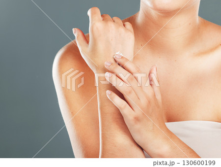 Hands, beauty cream and skincare of a woman with moisturizer on arms and hand in studio. Isolated, gray background and person with cosmetic, dermatology and spa lotion for skin with mockup Hands, beauty cream and skincare of a woman with moisturizer on arms and hand in studio. Isolated, gray background and person with cosmetic, dermatology and spa lotion for skin with mockup 130600199