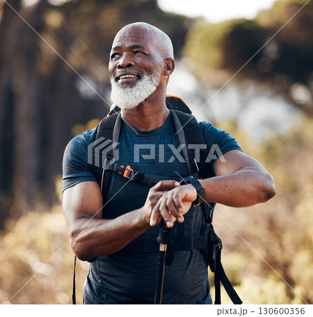 Hiking, man and smart watch for travel in nature forest for trekking, fitness and cardio exercise. Senior black person with backpack and gps clock outdoor in woods for adventure, health and wellness 130600356