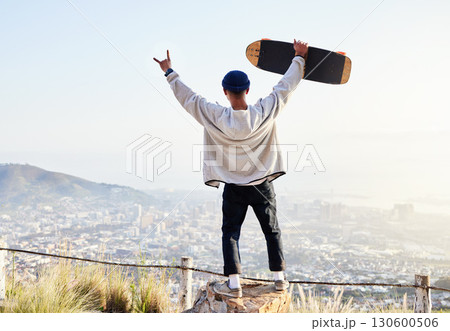Skateboard, freedom and mountains with man cheering for fitness, sports and adventure. Happiness, commitment and training with gen z guy skating in outdoors for travel, wellness and summer break 130600506