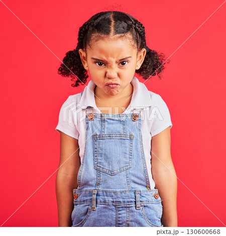 Child, portrait or angry face on isolated red background in emoji tantrum, behavior or stubborn studio problem. Mad, annoyed or frustrated little girl and sulking, grumpy or anger facial expression 130600668