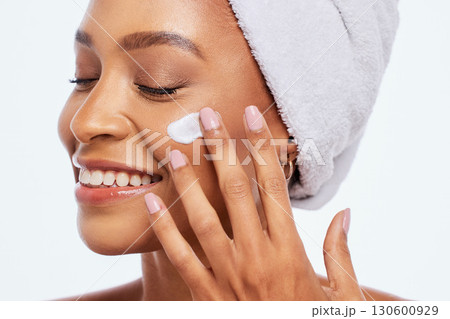 Black woman, beauty and skincare cream for face in studio for dermatology and cosmetics. Aesthetic model person hand on facial product for healthy and natural glow skin isolated on a white background Black woman, beauty and skincare cream for face in studio for dermatology and cosmetics. Aesthetic model person hand on facial product for healthy and natural glow skin isolated on a white background 130600929