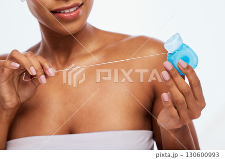 Dental, floss in hands and black woman, flossing for teeth whitening, health and hygiene isolated on white background. Oral care product, skincare and mouth cleaning for fresh breath in studio Dental, floss in hands and black woman, flossing for teeth whitening, health and hygiene isolated on white background. Oral care product, skincare and mouth cleaning for fresh breath in studio 130600993