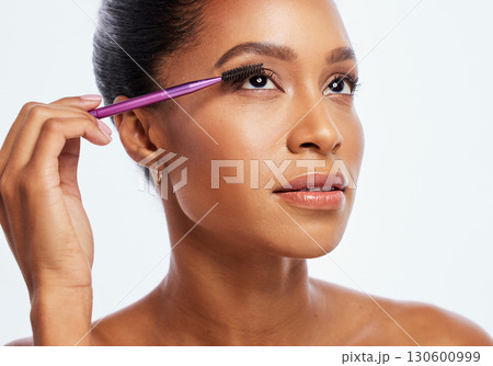 Eyelash, brush and makeup of black woman in studio for cosmetics, skincare and transformation. Face, beauty and mascara application for lashes, facial tool and eyes of model for beautiful aesthetic Eyelash, brush and makeup of black woman in studio for cosmetics, skincare and transformation. Face, beauty and mascara application for lashes, facial tool and eyes of model for beautiful aesthetic 130600999