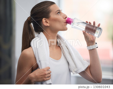 Fitness, woman and drinking water in gym for health, break and energy for workout, training or towel. Thirsty sports person, female and hydration with bottle, exercise nutrition and training wellness 130601043