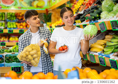 Happy young couple chooses products Happy young couple chooses products 130601162