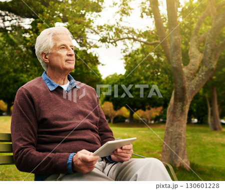 Relax, tablet and thinking with old man in park for social media, freedom and communication. Technology, internet and contact with senior citizen on bench in nature for website, peace and retirement 130601228