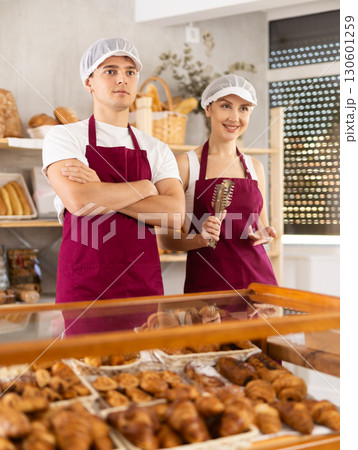 Young sellers standing in bake house, ready to greet customers Young sellers standing in bake house, ready to greet customers 130601259
