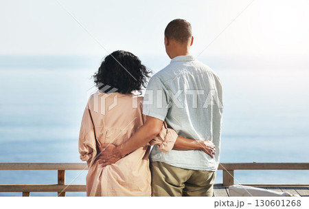 Back, view and senior couple by beach, hug and enjoying quality time on holiday or vacation. Love, care and retired elderly man and woman hugging, embrace or cuddle while having fun by ocean or sea. 130601268