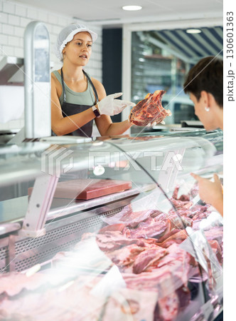 female butcher skillfully presents female butcher skillfully presents 130601363