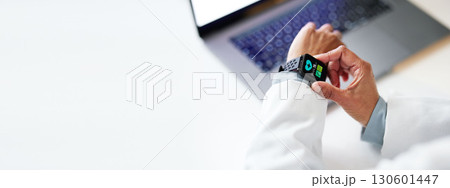 Doctor hands, smartwatch and closeup in office by laptop for health, wellness or time in hospital. Medical expert reading, iot tech watch or monitor healthcare for blood pressure at clinic workplace Doctor hands, smartwatch and closeup in office by laptop for health, wellness or time in hospital. Medical expert reading, iot tech watch or monitor healthcare for blood pressure at clinic workplace 130601447