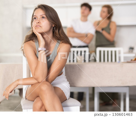 Mother-in-law and son scold young daughter-in-law in home kitchen Mother-in-law and son scold young daughter-in-law in home kitchen 130601463