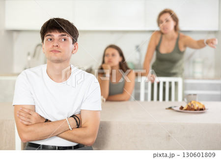 Woman mother and young girl during family quarrel accuse adult son Woman mother and young girl during family quarrel accuse adult son 130601809