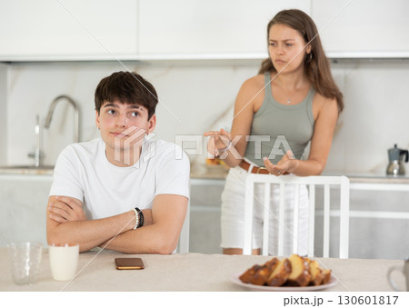 Young woman quarrels with young guy in kitchen 130601817