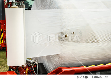 Bale of hay wrapped in plastic foil 130602036