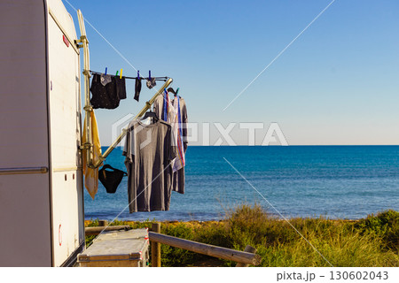 Caravan on beach with clothes to dry 130602043