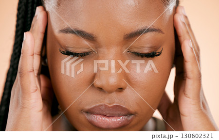 Black woman, face and closed eyes with headache, pain or suffering from stress against a studio background. Closeup of African American female holding head or painful area in mental health problems 130602321