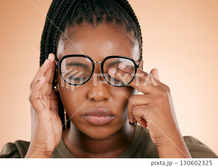 Black woman with glasses, tired and rubbing eyes, burnout and stress isolated on studio background. Vision, eye sight and overworked or exhausted person with spectacles, hands on face from allergy. 130602325