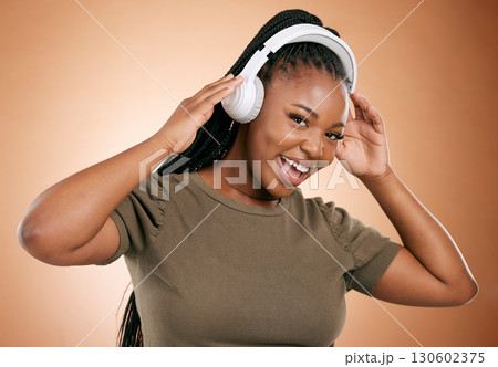 Headphones, music and black woman in portrait isolated on studio background for mental health, energy and podcast. Happy african person listening to audio technology with smile on face for sound Headphones, music and black woman in portrait isolated on studio background for mental health, energy and podcast. Happy african person listening to audio technology with smile on face for sound 130602375