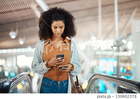 Travel, phone and scrolling with black woman in airport for social media, relax and networking. Flight, departure and holiday with girl passenger on escalator for communication, vacation and contact 130602378