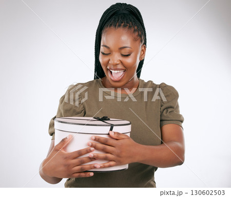 Gift, box and black woman on studio background, present or smile. Happy female, package and surprise with ribbon for birthday, excited celebration and wow product of promotion, happiness and giveaway Gift, box and black woman on studio background, present or smile. Happy female, package and surprise with ribbon for birthday, excited celebration and wow product of promotion, happiness and giveaway 130602503