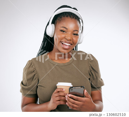 Portrait, music and coffee with a black woman in studio on a gray background listening to the radio. Phone, social media or headphones and a young female streaming an audio playlist with a drink Portrait, music and coffee with a black woman in studio on a gray background listening to the radio. Phone, social media or headphones and a young female streaming an audio playlist with a drink 130602510