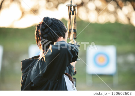Archer, arrow target training and practice for archery competition, athlete challenge or competitive shooting. Sports field girl, bow hunting and woman focus on precision, aim or back view objective Archer, arrow target training and practice for archery competition, athlete challenge or competitive shooting. Sports field girl, bow hunting and woman focus on precision, aim or back view objective 130602608