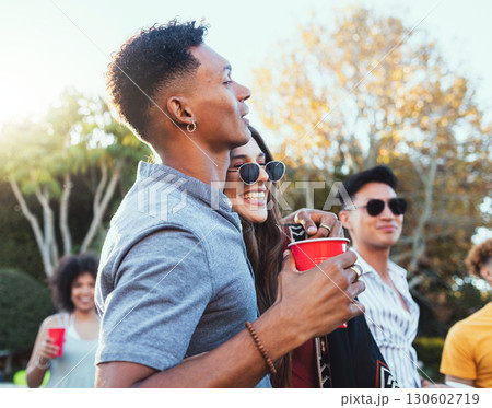 Drinks, party and a couple of friends outdoor to celebrate at festival, concert or summer social event. Diversity young men and women crowd while happy, hug and drinking alcohol while listening Drinks, party and a couple of friends outdoor to celebrate at festival, concert or summer social event. Diversity young men and women crowd while happy, hug and drinking alcohol while listening 130602719