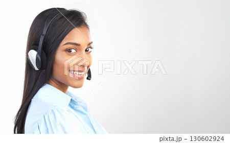 Customer support, call center and portrait of a Indian woman with mockup studio. Telemarketing, crm and empoyee work conversation with a smile from web help sale consultation online with mock up 130602924