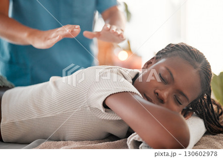 Relax, reiki and black woman on bed with eyes closed at spa for chakra therapy and holistic medicine. Spiritual healing, balance and zen, person with peaceful and healthy mind at traditional massage. Relax, reiki and black woman on bed with eyes closed at spa for chakra therapy and holistic medicine. Spiritual healing, balance and zen, person with peaceful and healthy mind at traditional massage. 130602978